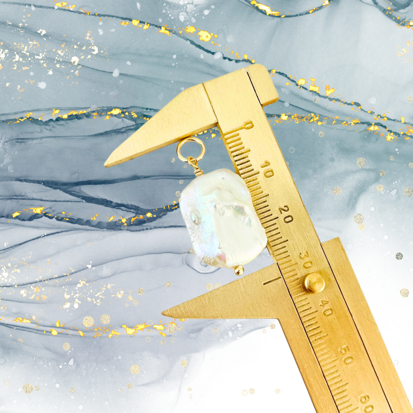 Gold caliper measuring a Biwa rectangle Pearl against