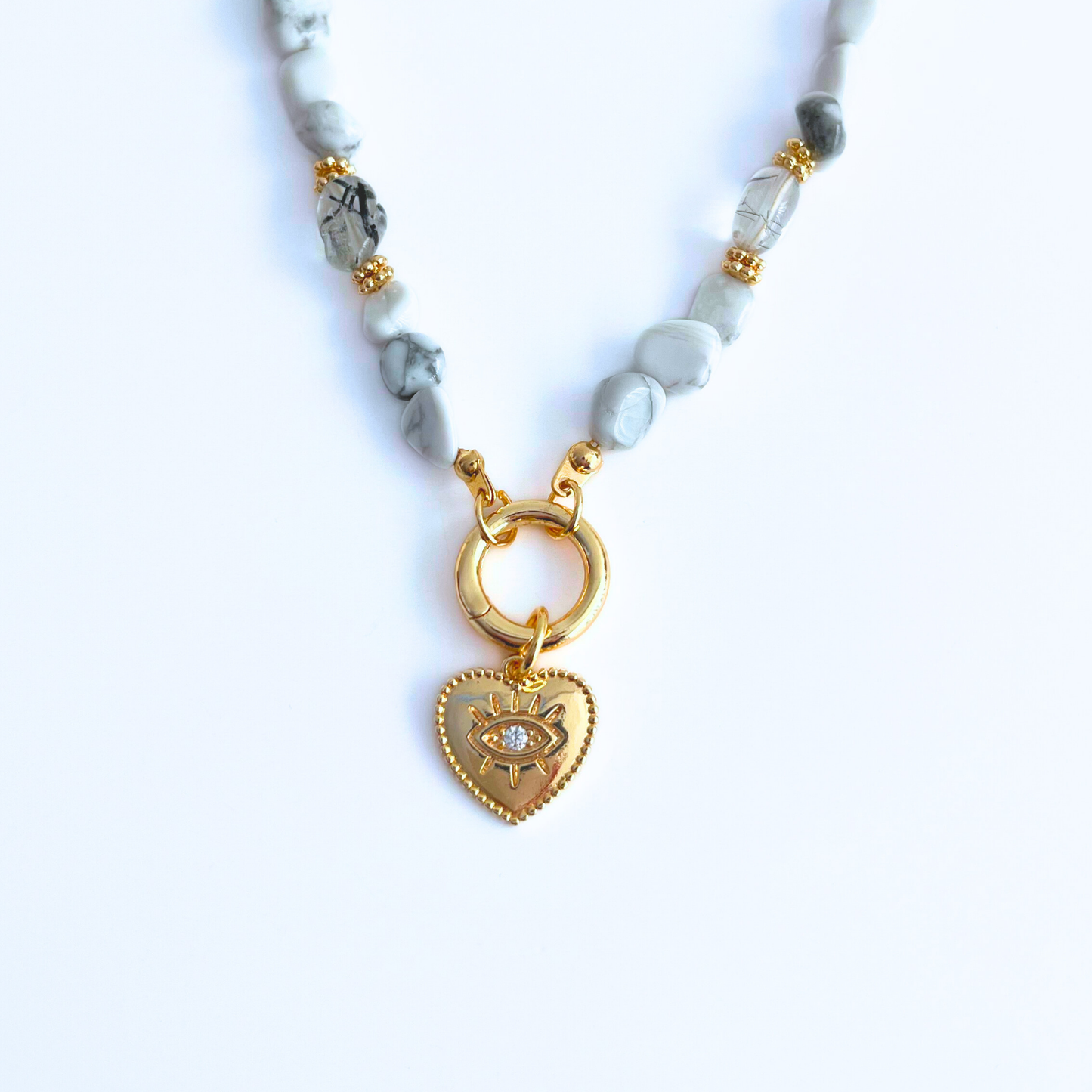 natural howlite gemstone Necklace with Gold Plated CZ Evil Eye Heart Pendant on a white background