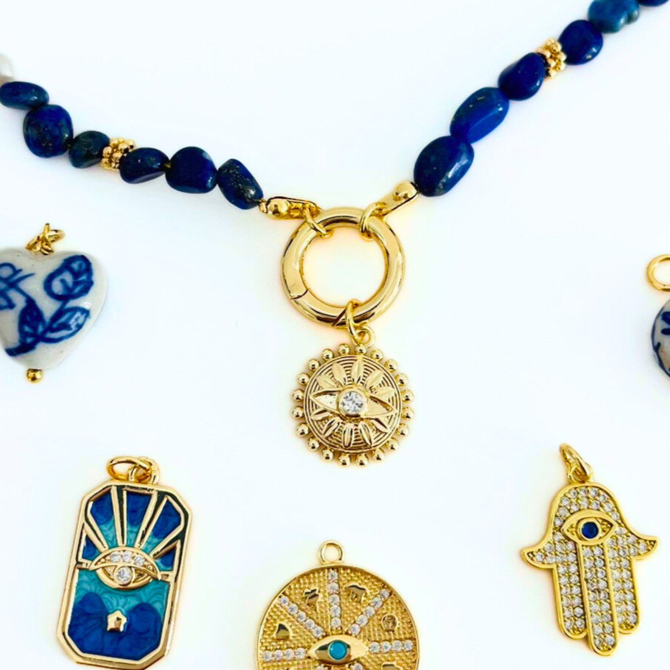 Lapis Lazuli Gemstone Necklace with a Gold Plated Bolt clasp and pendants on a white background, featuring a pendant sold separately text.