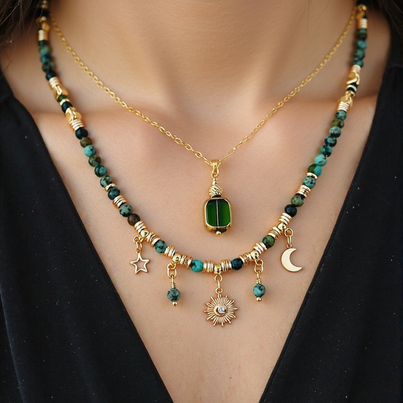 Necklace with green beads and gold accents on a black background