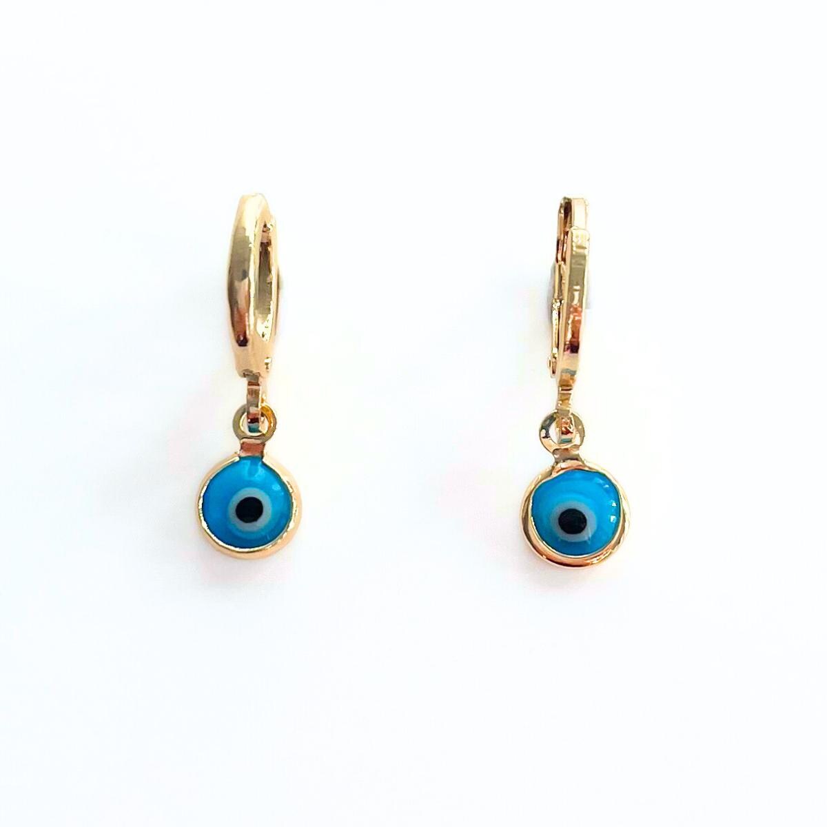 Gold plated hoop earrings with blue evil eye charms on a white background