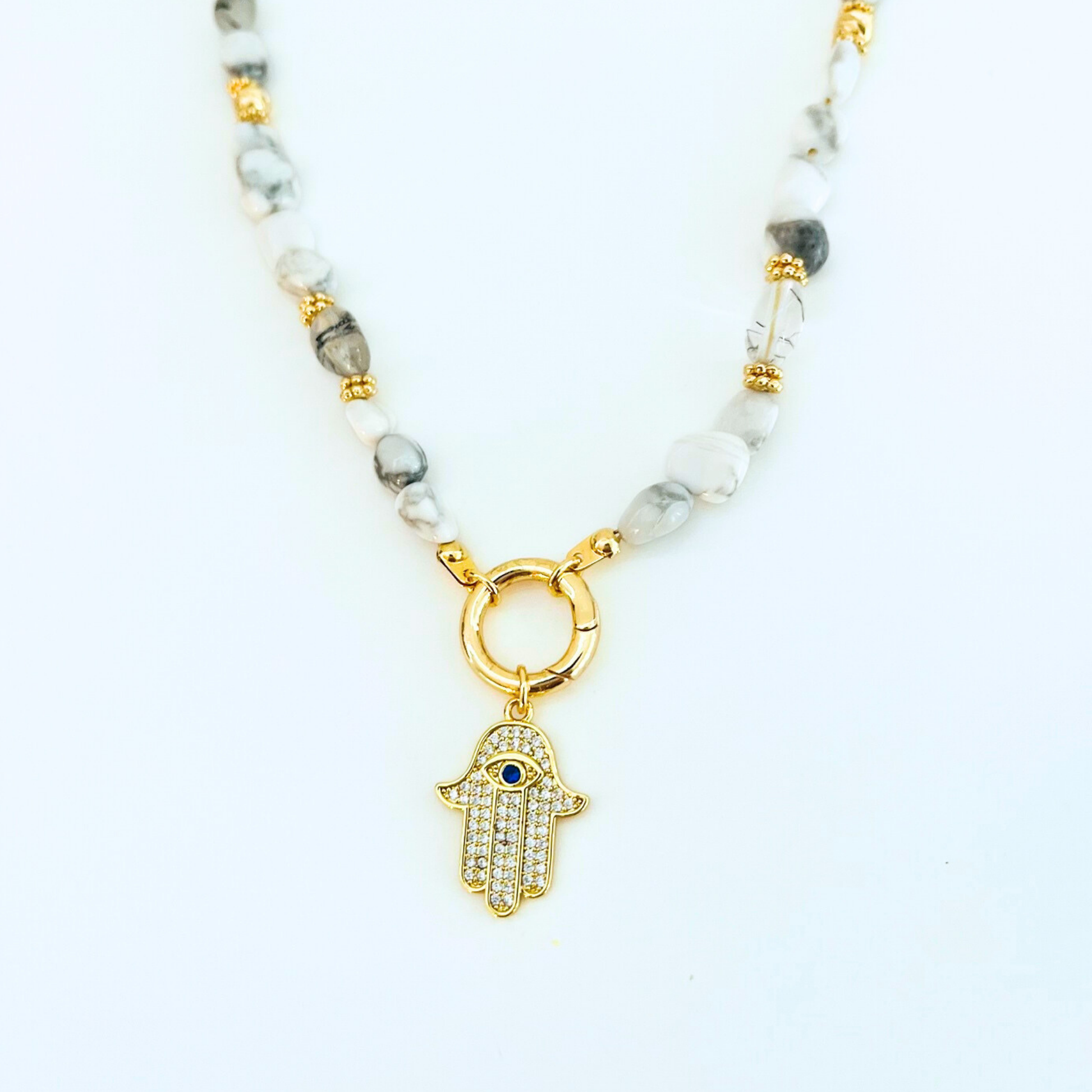 natural howlit gemstone Necklace with a CZ Hamsa Hand Evil Eye Pendant on a white background
