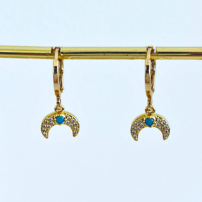 CZ Moon Gold Plated Huggie Hoop earrings hang on a gold bar