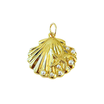 Gold pendant shaped like a shell with pearls and a starfish on a white background