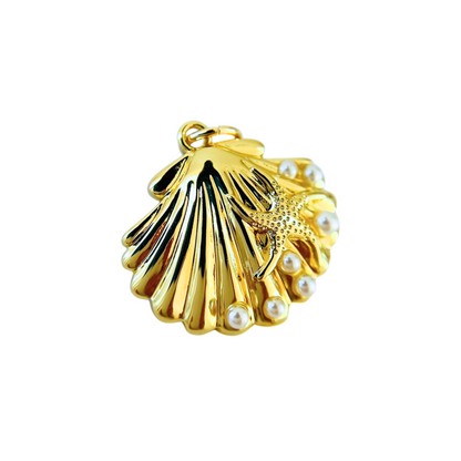 Gold shell pendant with pearls on a white background