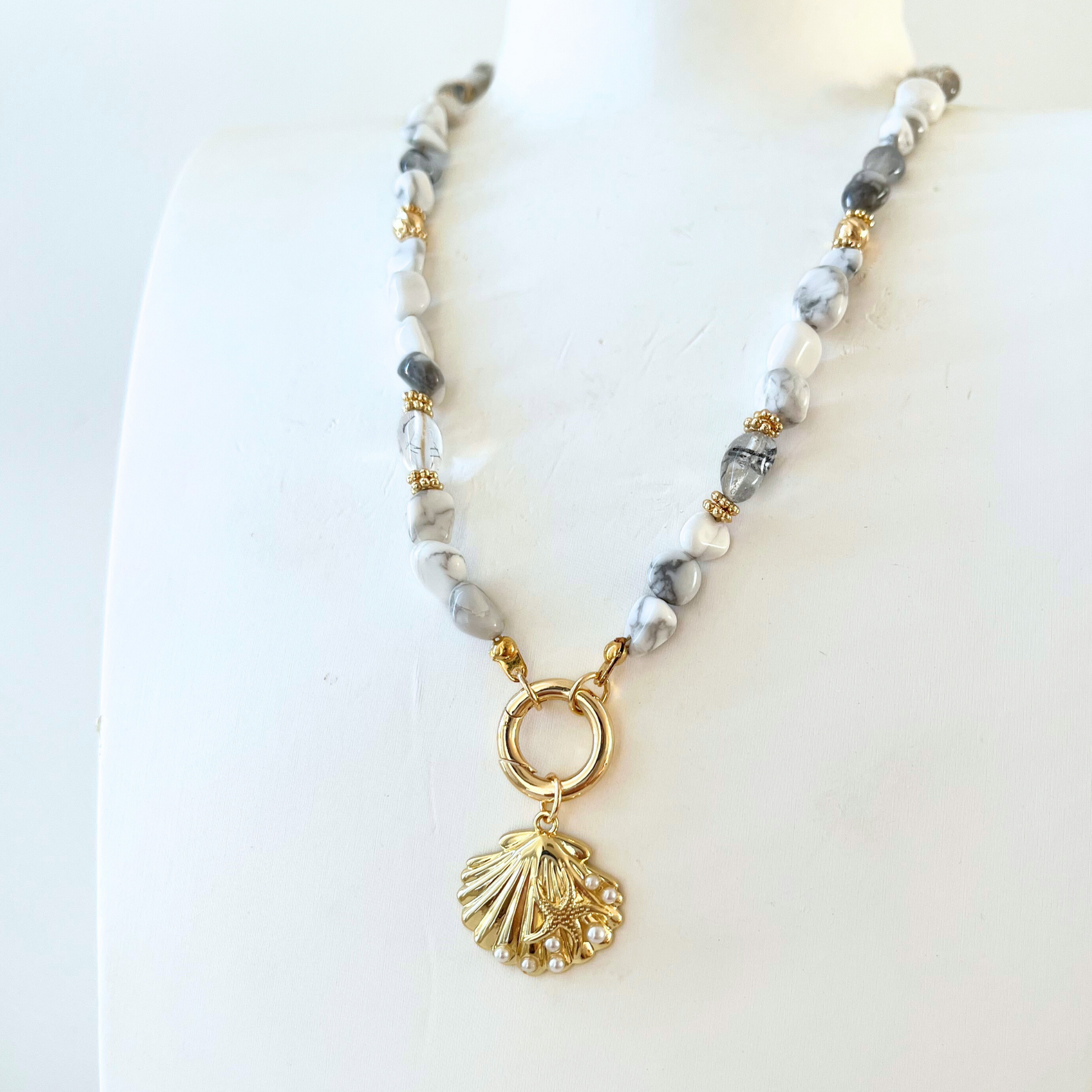 Howlite Gemstone Necklace with gray beads and a gold shell pendant 