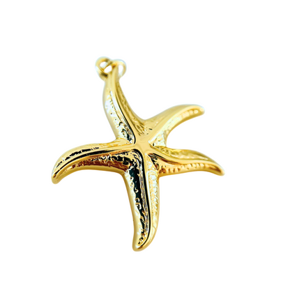 Gold starfish pendant on a white background