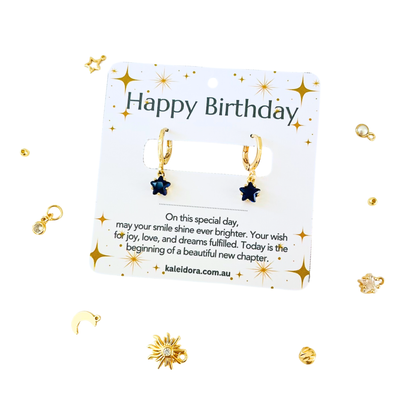 September Birthstone Sapphire CZ Star Hoop Earrings on a 'Happy Birthday' card on a light  background