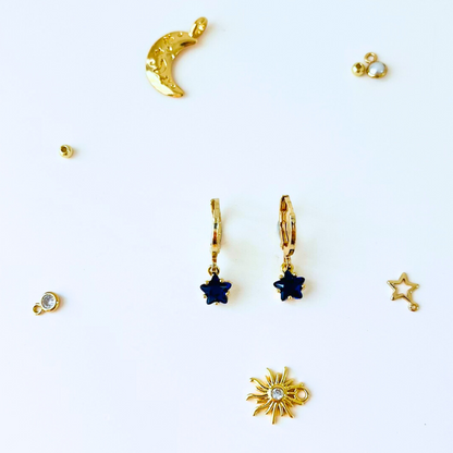 September Birthstone Sapphire CZ Star Hoop Earrings with Collection of gold  jewelry pieces on a white background