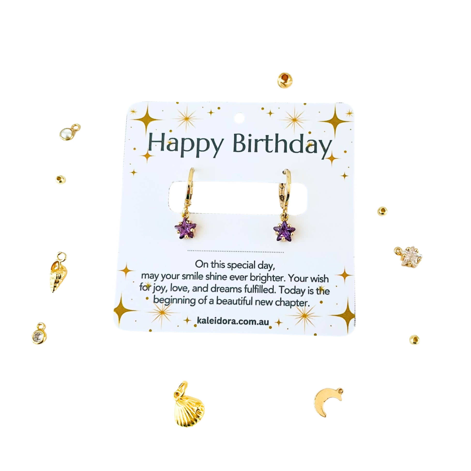 Gold earrings with star and shell charms on a 'Happy Birthday' card with decorative elements.