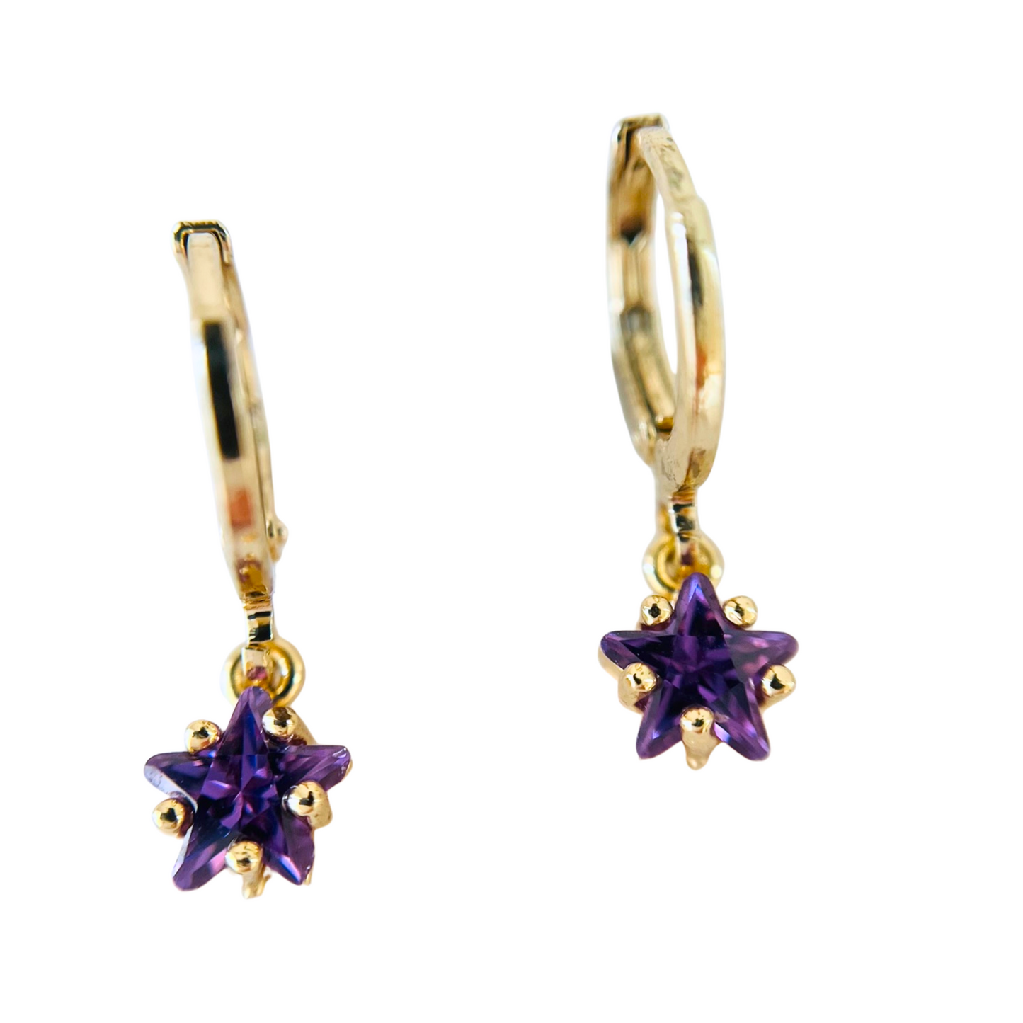 Gold hoop earrings with purple star-shaped gemstones on a white background