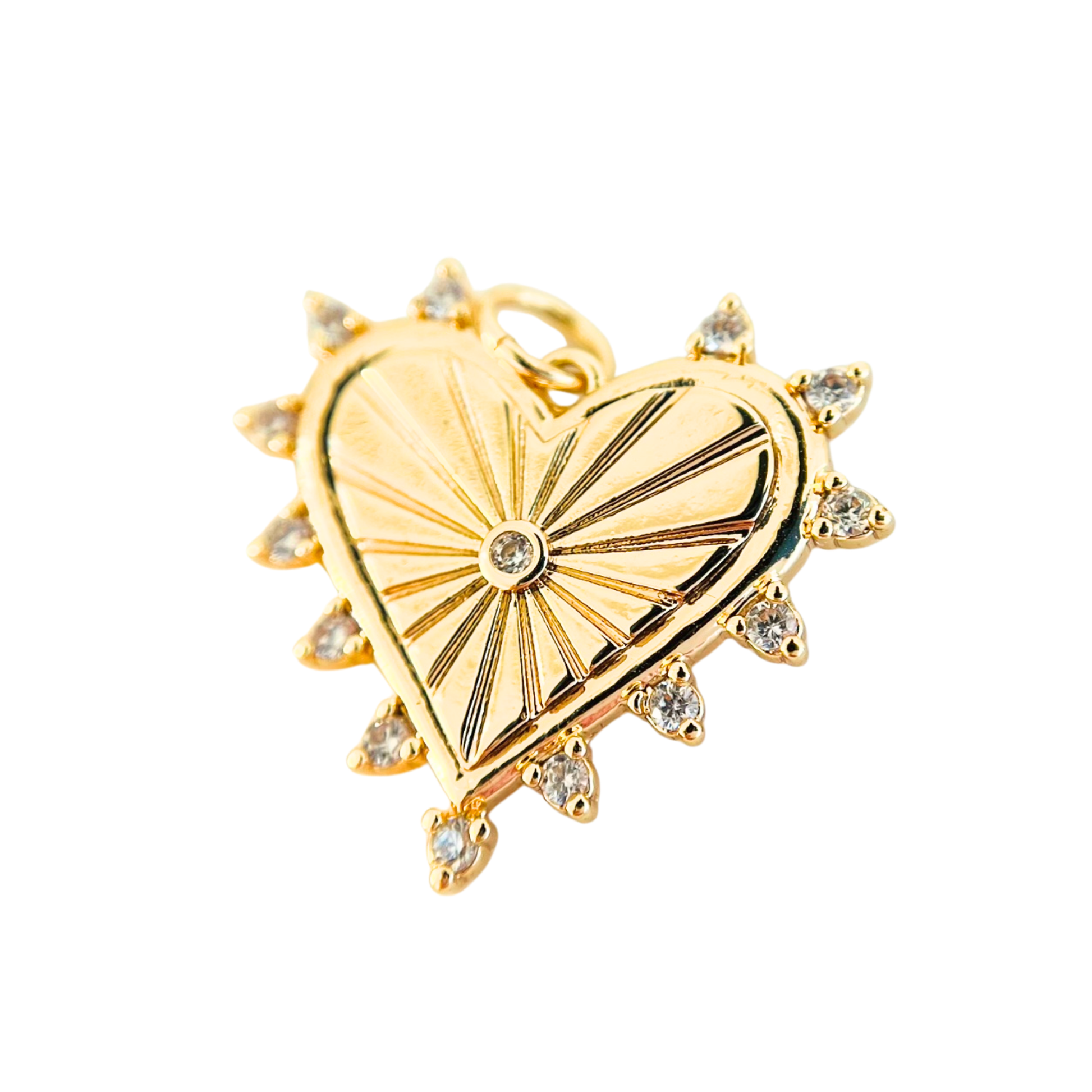 Gold heart-shaped pendant with sunburst design and small CZ on a white background