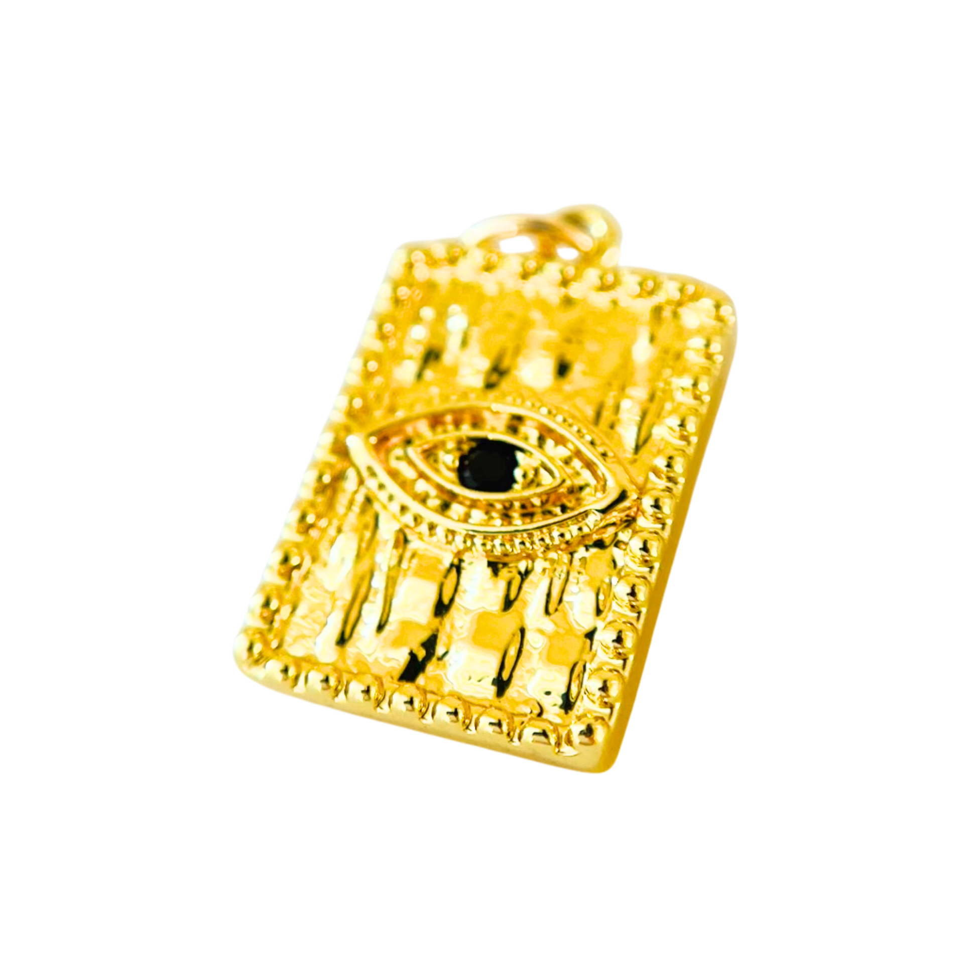 Gold pendant with an eye design on a white background