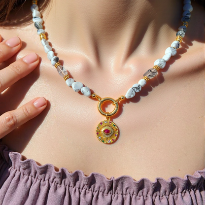 natural howlite gemstone Necklace Gold Plated Evil Eye Round Pendant with Magenta CZ - Protection Jewelry worn by a women, with a focus on the jewelry.