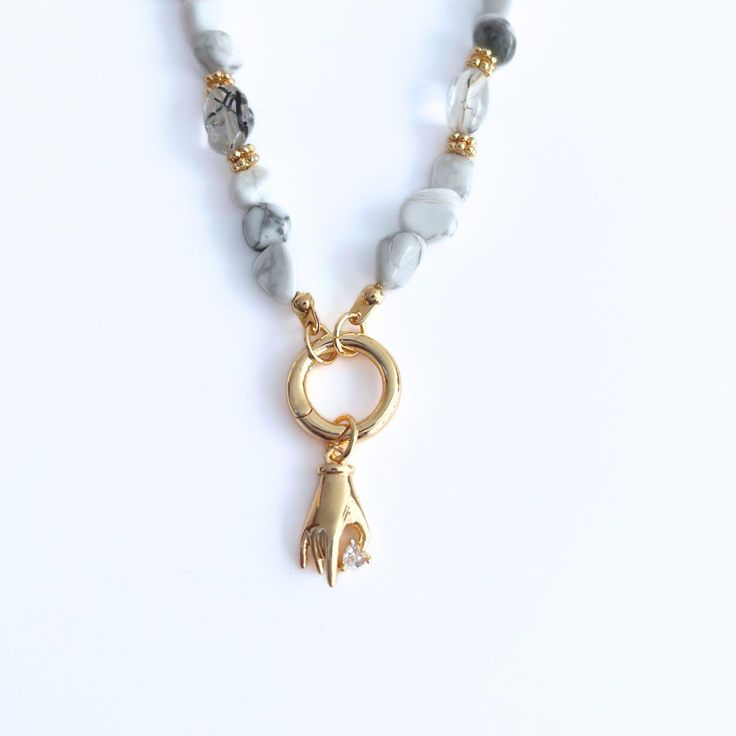 natural howlite gemstone Necklace with Gold Plated Hand Heart CZ Pendant on a white background