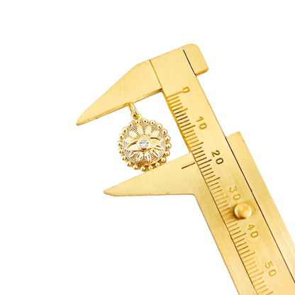 Gold Plated Sunburst Evil Eye Pendant on a gold caliper against a white background