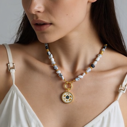 Woman wearing a natural howlite gemstone necklace with Gold Plated Symbols Medallion Pendant - Spiritual Jewelry