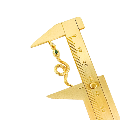 Green CZ Eyes Gold Plated Snake Pendant being measured by a gold caliper on a white background