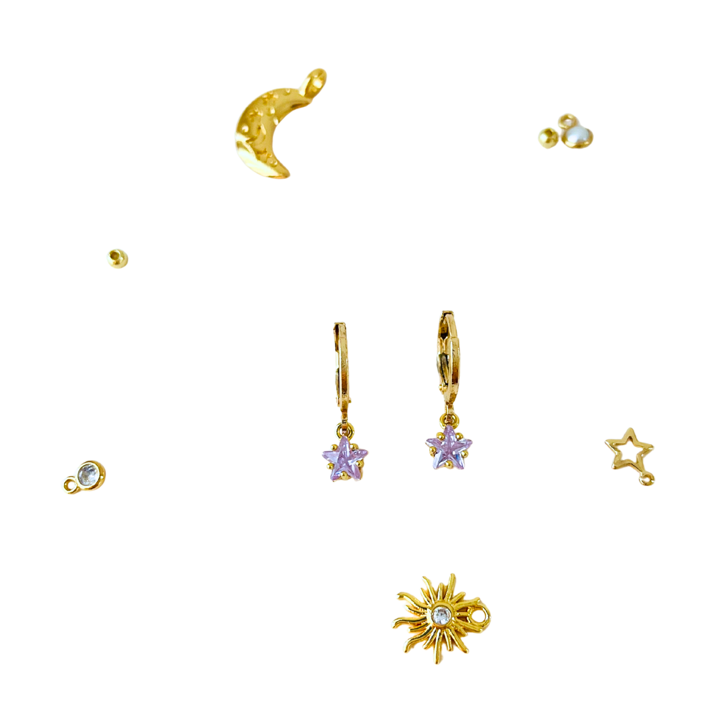 Collection of gold earrings with celestial designs on a white background
