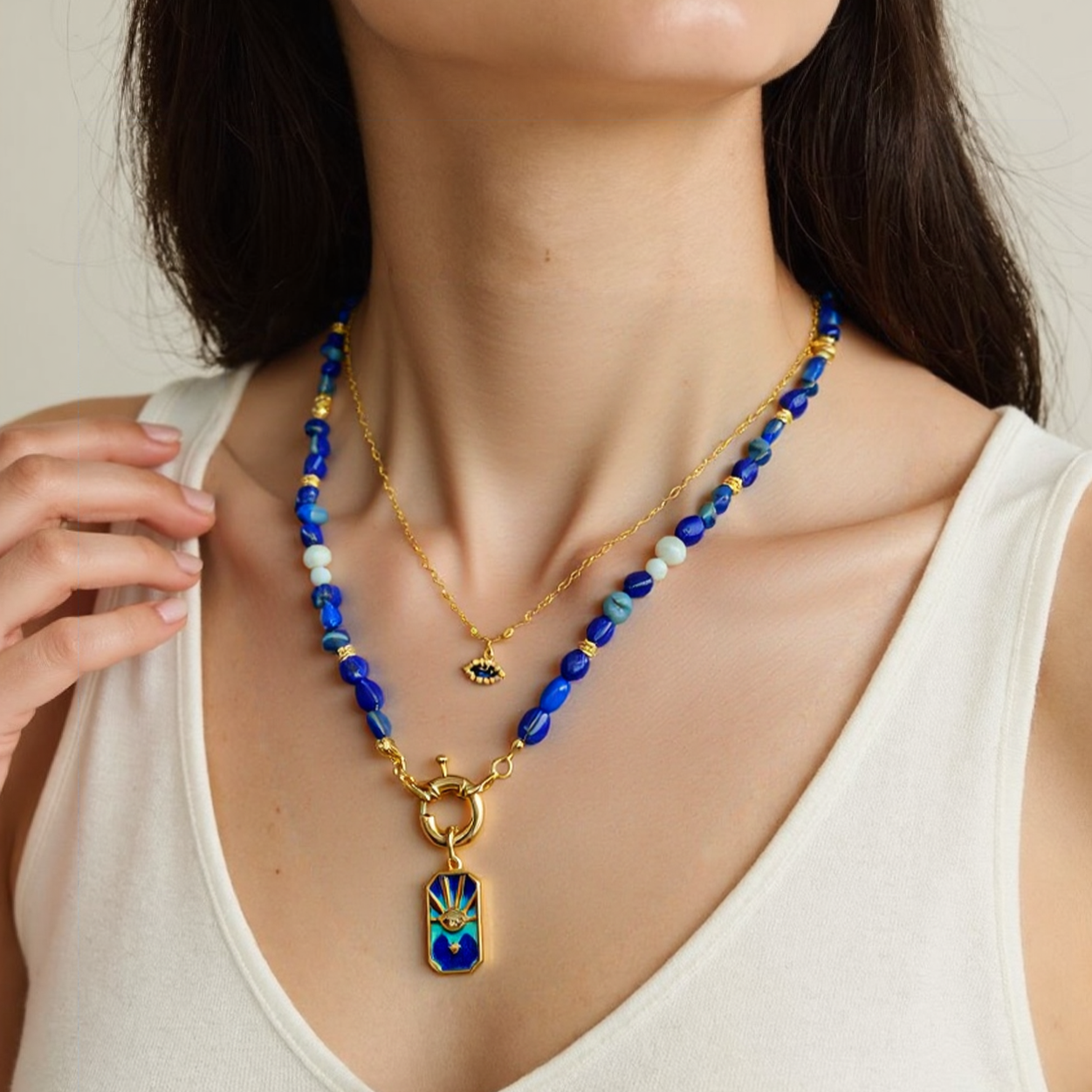 Woman wearing a Lapis Lazuli Gemstone necklace with a Blue Enamel Evil Eye Star Pendant.