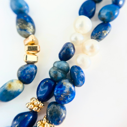 Lapis Lazuli Gemstone , gold spacers, and pearls on a white background