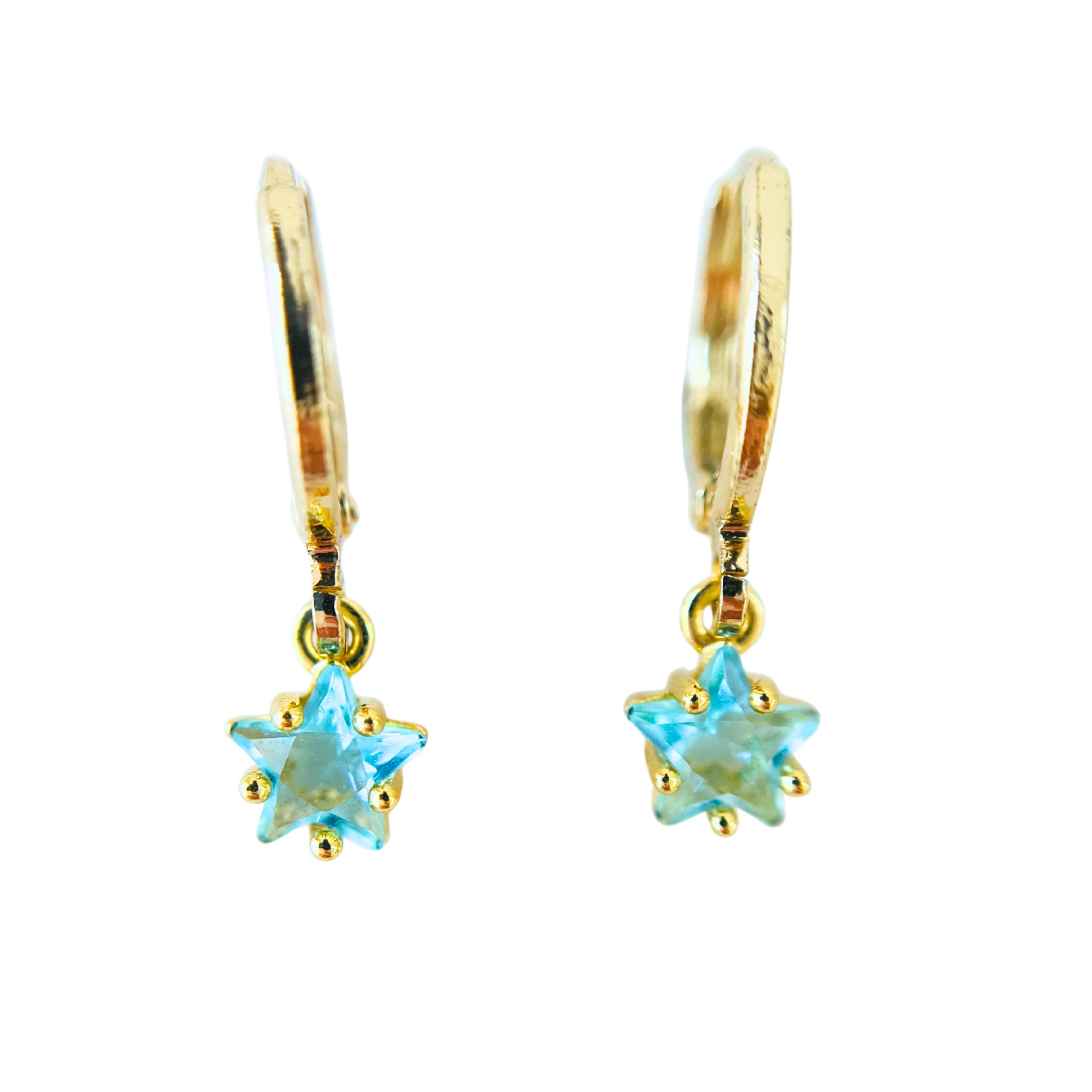 Gold earrings with star-shaped blue gemstones on a white background