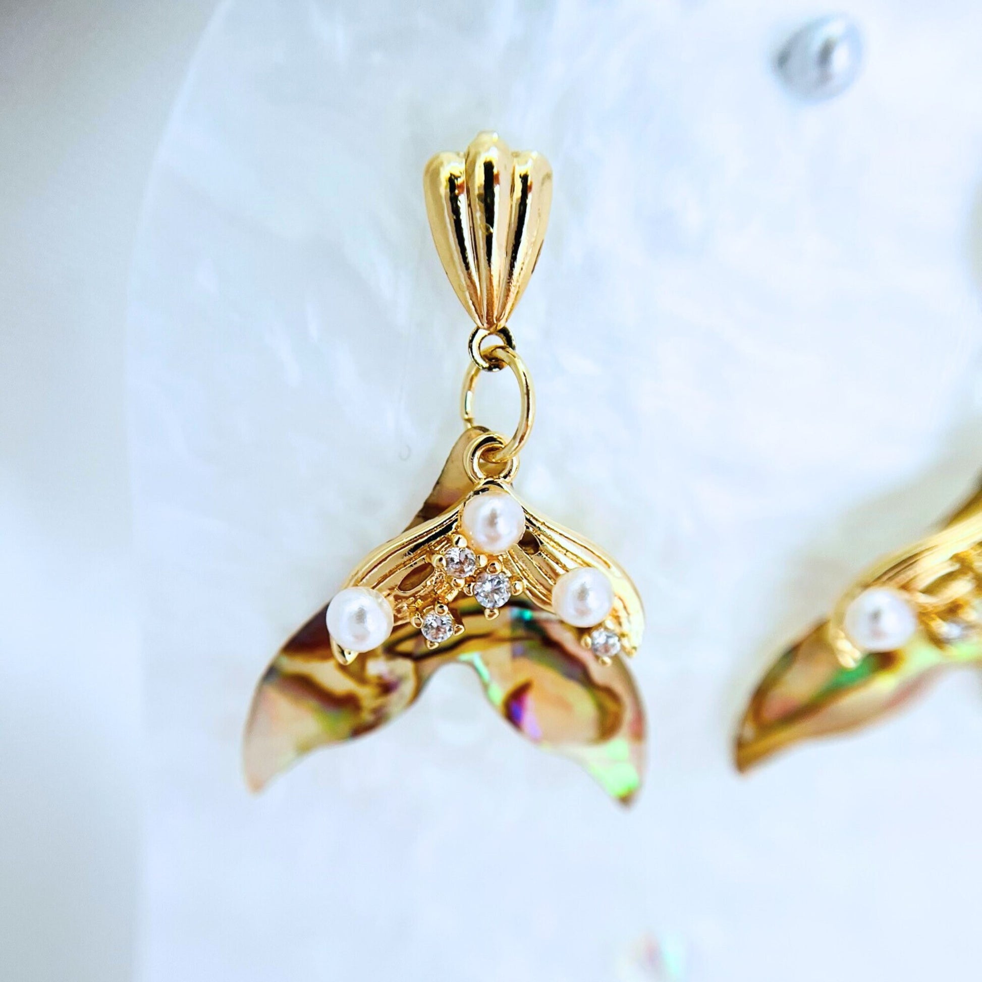 close Gold Mermaid Earring on a white background