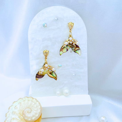 Pair of Mermaid Earrings on a white stand with a light blue background